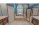 The bathroom features a tub below an arched window, and a separate glass enclosed shower at 19 Rivers Edge Ct, Timberlake, NC 27583