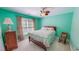 Cozy bedroom with a ceiling fan, floral bedding, and natural light from the window at 19 Rivers Edge Ct, Timberlake, NC 27583