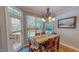 Sunny dining area with large windows and a view of the backyard and back deck at 19 Rivers Edge Ct, Timberlake, NC 27583