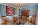 Dining room featuring a wood table, hutch, and stylish decor with blue walls at 19 Rivers Edge Ct, Timberlake, NC 27583