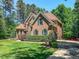 Beautiful brick home with mature landscaping, green lawn and driveway on a sunny day at 19 Rivers Edge Ct, Timberlake, NC 27583