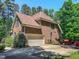 Brick house with a two-car garage, well-manicured lawn, and mature trees at 19 Rivers Edge Ct, Timberlake, NC 27583