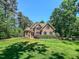 Beautiful brick home with lush green lawn and mature trees at 19 Rivers Edge Ct, Timberlake, NC 27583
