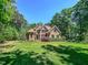 Beautiful brick home with manicured lawn and mature trees at 19 Rivers Edge Ct, Timberlake, NC 27583