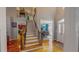 Inviting foyer with hardwood floors, staircase, and views of the dining and kitchen at 19 Rivers Edge Ct, Timberlake, NC 27583
