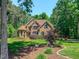 Charming two-story brick home with manicured landscaping and mature trees at 19 Rivers Edge Ct, Timberlake, NC 27583