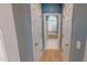 Hallway view showing the bathroom at the end with bathtub under an arched window at 19 Rivers Edge Ct, Timberlake, NC 27583