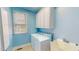 Well-lit laundry room with washer, dryer, sink, and overhead cabinets at 19 Rivers Edge Ct, Timberlake, NC 27583