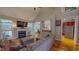 Open-concept living room with a fireplace, hardwood floors, and ample natural light at 19 Rivers Edge Ct, Timberlake, NC 27583