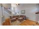 Spacious living room with high ceilings, hardwood floors, and a cozy sectional sofa at 19 Rivers Edge Ct, Timberlake, NC 27583