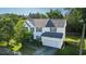 Expansive aerial view of a white two-story home with well-kept lawn and mature trees at 1909 Redding Lane, Durham, NC 27712