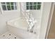 Bright bathroom featuring a soaking tub with dual windows for natural light at 1909 Redding Lane, Durham, NC 27712