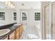 Bright bathroom with double vanity, shower, and tub, accented by natural light from multiple windows at 1909 Redding Lane, Durham, NC 27712