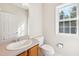 Bright bathroom featuring a single vanity, toilet, and window, offering a clean and functional space at 1909 Redding Lane, Durham, NC 27712