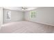 Spacious bedroom with two windows and a ceiling fan, offering natural light and airflow for comfort at 1909 Redding Lane, Durham, NC 27712