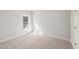 Cozy bedroom features carpeted floors, neutral walls, and a window allowing natural light, creating a tranquil space at 1909 Redding Lane, Durham, NC 27712