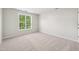 Bedroom featuring neutral carpet, a large window and light walls at 1909 Redding Lane, Durham, NC 27712