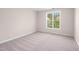 Clean bedroom with neutral carpet and paint, offering a blank canvas with ample natural light at 1909 Redding Lane, Durham, NC 27712
