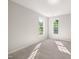 Neutral bedroom with two windows providing natural light and a peaceful ambiance to the room at 1909 Redding Lane, Durham, NC 27712