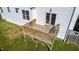 A wooden deck with stairs adds outdoor living space to the white house and green lawn at 1909 Redding Lane, Durham, NC 27712