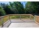 View of wooden deck overlooking the lush backyard, perfect for entertaining at 1909 Redding Lane, Durham, NC 27712