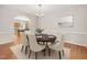 Dining room with a round table, chairs, and view into the bright kitchen at 1909 Redding Lane, Durham, NC 27712