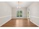 Dining room features hardwood floors, a modern chandelier and a large picture window at 1909 Redding Lane, Durham, NC 27712