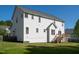 Exterior view of home showcasing a spacious backyard with a wooden deck at 1909 Redding Lane, Durham, NC 27712