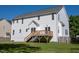 Exterior view of home showcasing a spacious backyard with a wooden deck at 1909 Redding Lane, Durham, NC 27712