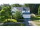 A well-maintained two-story home with blue shutters and a mature tree in the front yard at 1909 Redding Lane, Durham, NC 27712