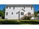 Exterior view of home showcasing a spacious backyard with a wooden deck at 1909 Redding Lane, Durham, NC 27712