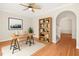 Bright home office featuring a ceiling fan, a modern desk, and a stylish bookshelf at 1909 Redding Lane, Durham, NC 27712