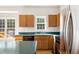 Kitchen features wood cabinets, stainless steel appliances, and a view to the outside at 1909 Redding Lane, Durham, NC 27712