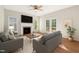 Open living room featuring fireplace, two couches, and backyard access at 1909 Redding Lane, Durham, NC 27712