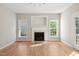 Bright living room features hardwood floors and a fireplace with white mantle at 1909 Redding Lane, Durham, NC 27712