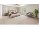 Staged primary bedroom with neutral paint, carpet, and furniture at 1909 Redding Lane, Durham, NC 27712