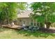 View of the backyard featuring an outdoor seating area, a well-manicured lawn, and mature trees for shade and privacy at 20 Keswick Ct, Durham, NC 27713
