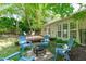 This backyard retreat features a patio with outdoor furniture, string lights, and a well-manicured lawn next to the home at 20 Keswick Ct, Durham, NC 27713