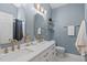 This bathroom includes double sinks, gold accents, and updated lighting at 20 Keswick Ct, Durham, NC 27713
