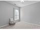 This bedroom features neutral walls and carpet and a window for natural light at 20 Keswick Ct, Durham, NC 27713