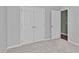 This bedroom includes carpet, an open door, and a double-door closet for storage at 20 Keswick Ct, Durham, NC 27713