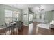 Inviting dining room and living room featuring stylish decor, wood floors, and lots of natural light at 20 Keswick Ct, Durham, NC 27713