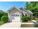 Charming single-Gathering home featuring a well-maintained front yard, garage, and classic architectural details at 20 Keswick Ct, Durham, NC 27713