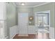 Inviting foyer with wood floors, decorative wall trim, and a view into the bright and airy living spaces at 20 Keswick Ct, Durham, NC 27713