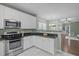 Well-equipped kitchen with stainless steel appliances and a breakfast bar overlooking the living room at 20 Keswick Ct, Durham, NC 27713