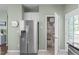 Convenient kitchen area with stainless steel refrigerator and access to pantry at 20 Keswick Ct, Durham, NC 27713