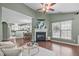 Comfortable living room featuring a fireplace, large window, and an open layout with views of the kitchen at 20 Keswick Ct, Durham, NC 27713