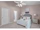 The main bedroom has neutral decor, a ceiling fan, and an ensuite bathroom at 20 Keswick Ct, Durham, NC 27713