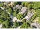 High angle view of a luxury home nestled in a lush, green forest with circular driveways and mature landscaping at 20011 Bragg, Chapel Hill, NC 27517