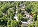 A charming aerial view of homes nestled between mature trees, offering a peaceful and nature-filled setting at 20011 Bragg, Chapel Hill, NC 27517